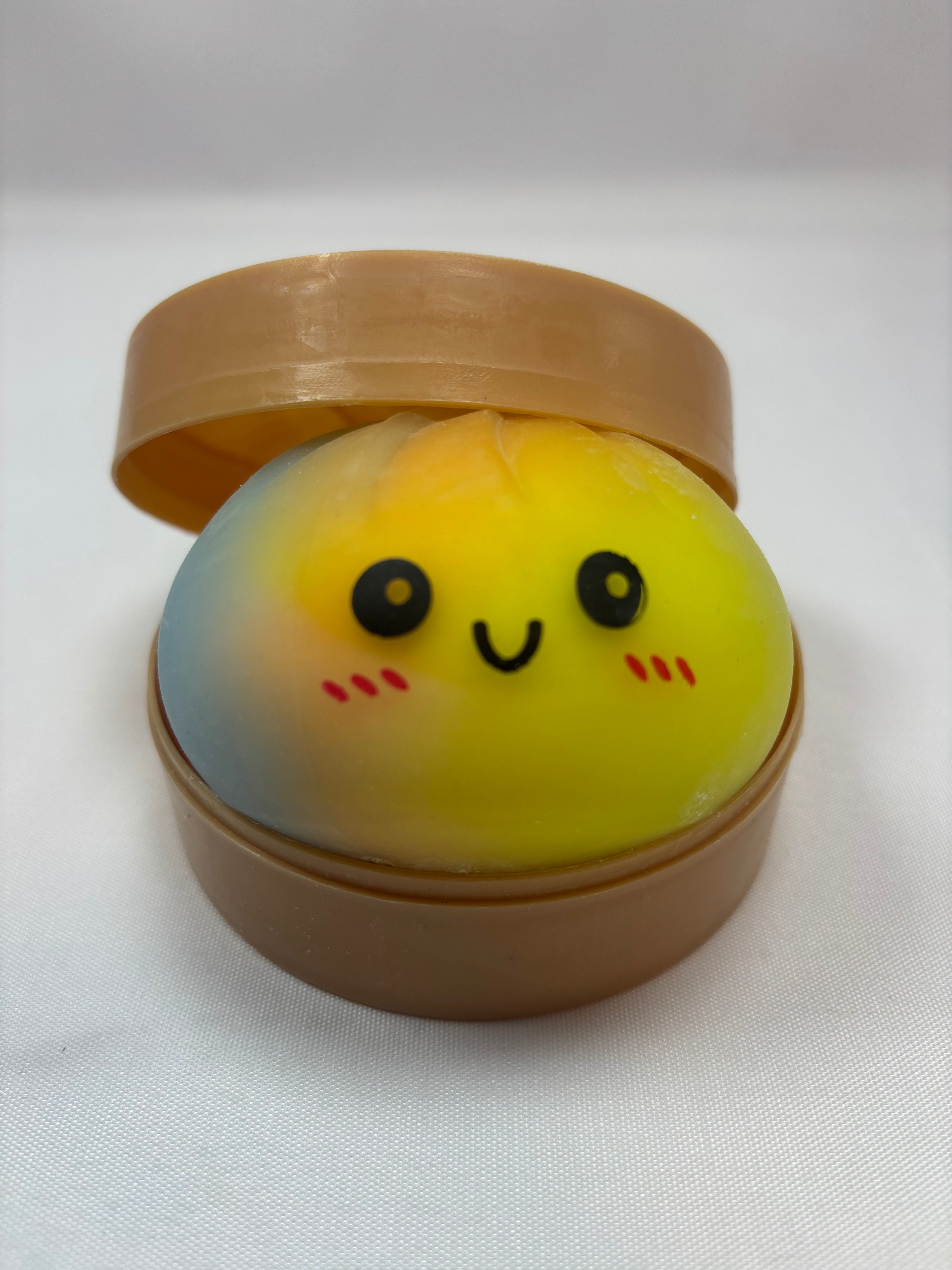 Jeu sensoriel Bun Squishy arc-en-ciel jaune, orange et bleu